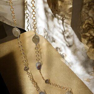 Versatile throw on and go long gold chain. The neutral stones allow it to go wit